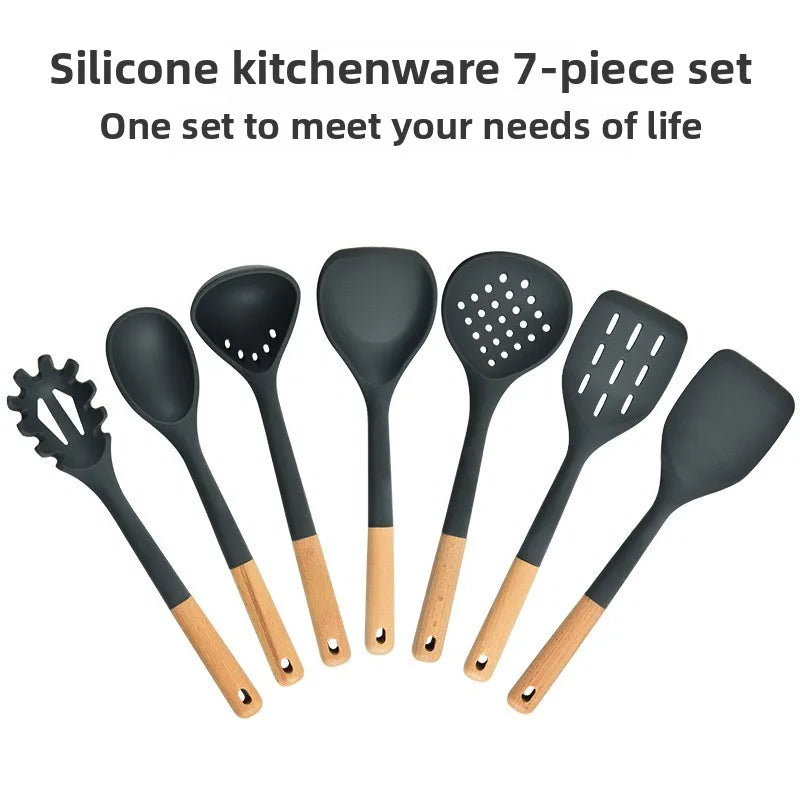 Silicone kitchenware set with wooden handles. Kitchen tools: silicone spatula, strainer, frying spatula