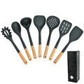 Silicone kitchenware set with wooden handles. Kitchen tools: silicone spatula, strainer, frying spatula